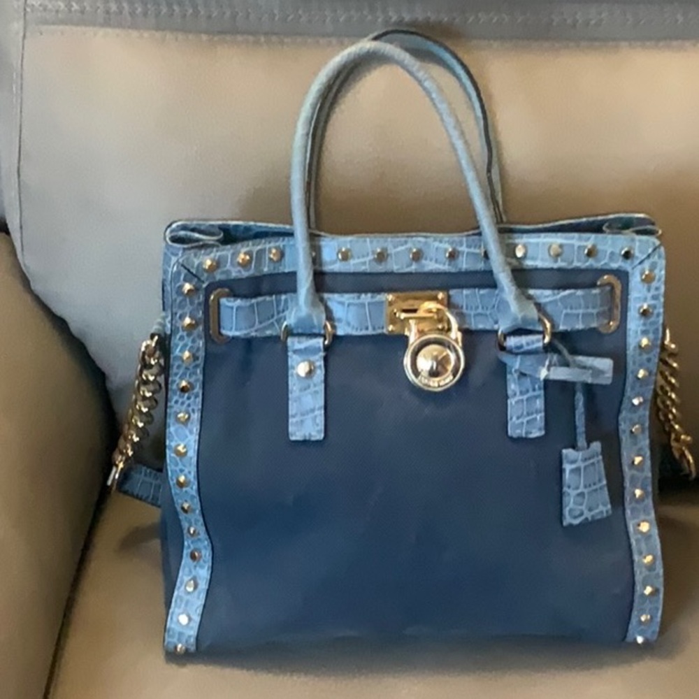 Blue denim authentic Michael Kors purse and wristlet with gold hardware.